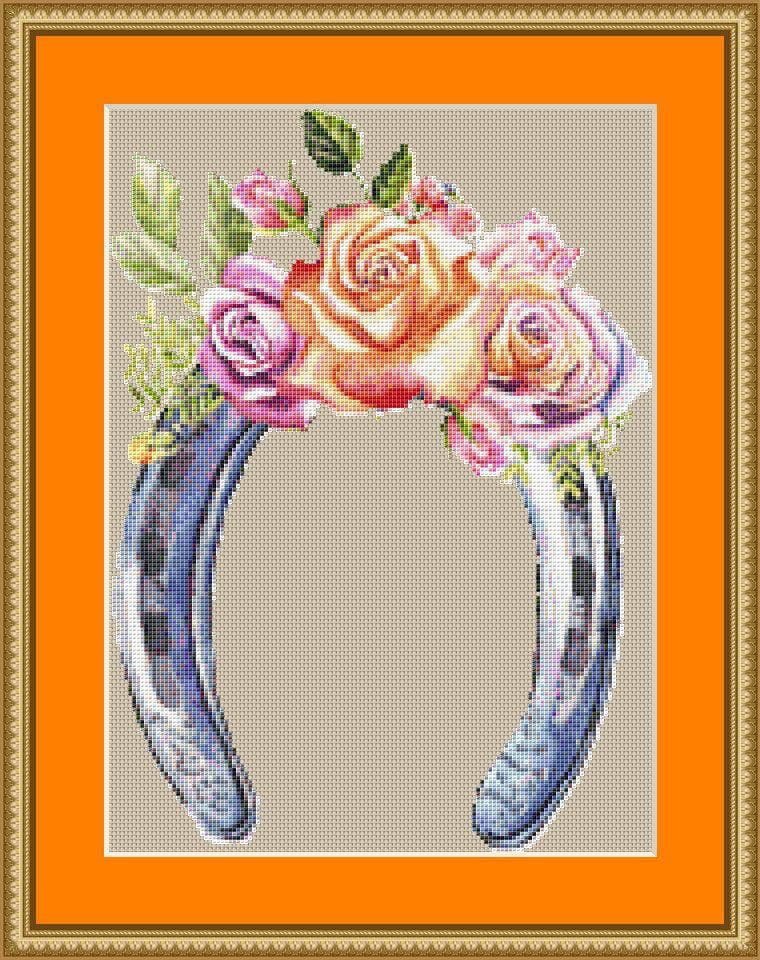 A cross stitch pattern of a horseshoe with flowers.
